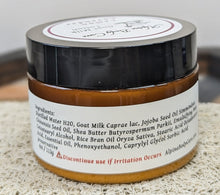 Load image into Gallery viewer, Jar of lotion with a label showing ingredients on a textured surface