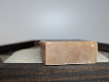Load image into Gallery viewer, Bar of soap on a textured surface with a neutral background