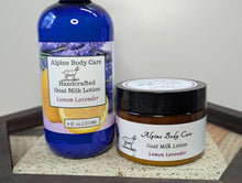 Load image into Gallery viewer, Alpine Body Care lemon lavender goat milk lotion bottle and jar on a textured surface.